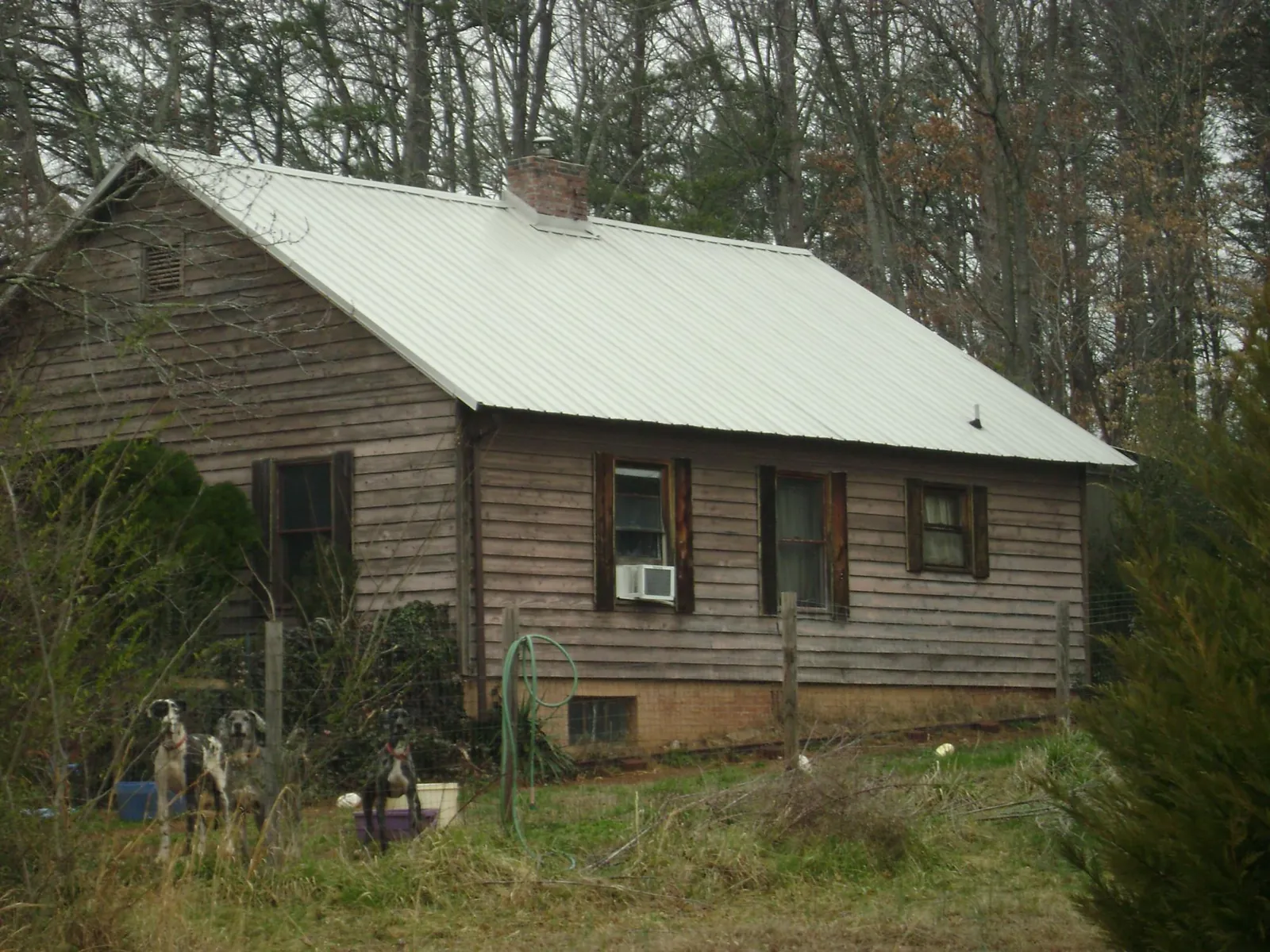 White metal roof on an old wood sided farmhouse, from a Metal Roof Installation job in Carpentersville